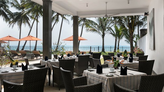 The outdoor dining area under ceiling fans on the verandah.