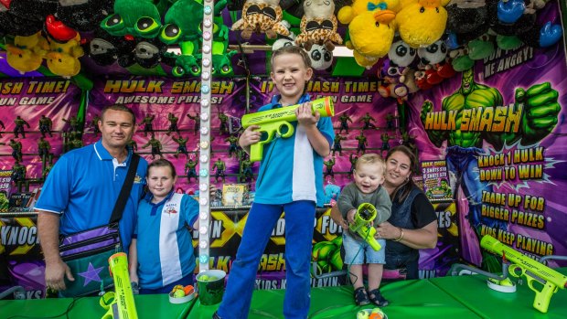Show family: Mekia McDonald, 6, centre, with, left to right, her father, Jesse, sister Chivani, baby brother Porter and mother Alicia, at their Hulk Smash sideshow at the Royal Melbourne Show.