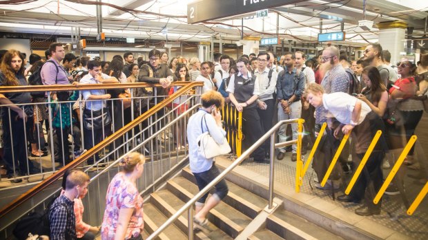 Station staff at Town Hall temporarily stop commuters from entering the platforms last week to avoid dangerous overcrowding.