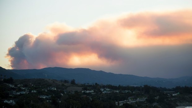 Seen from Carpinteria, California, smoke from a wildfire billows over Ventura.