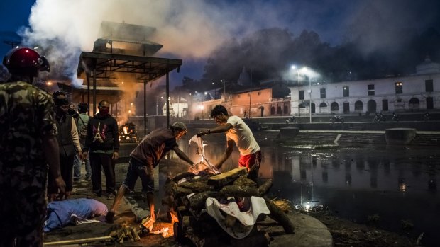 An earthquake victim's body is prepared for cremation in Kathmandu.