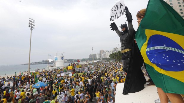 An anti-government demonstrator dressed as Batman holds a placard reading "Out Dilma" during a protest against Brazil's President Dilma Rousseff on Copacabana beach in Rio de Janeiro earlier this month.
