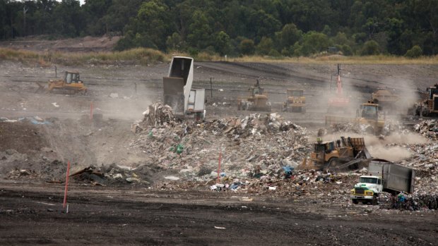 Waste trucks dump unprocessed construction waste from NSW at Cleanaway's New Chum landfill in Ipswich.