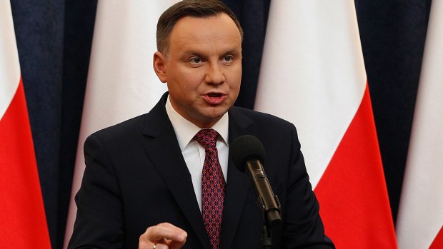 Polish President Andrzej Duda tells a news conference he decided to sign two laws that will put courts under more political control.