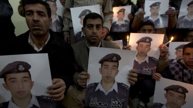 Family of Jordanian pilot Muath al-Kasasbeh with posters of him last week.