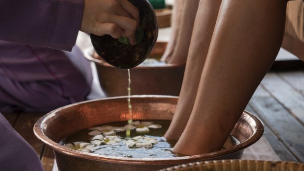 After landing on the luxury kelong's expansive deck, guests receive a ritual foot bath.