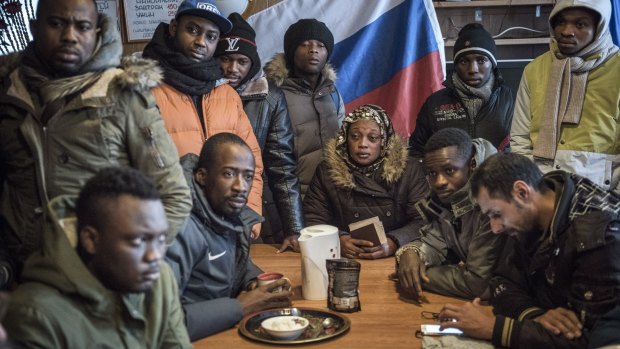 Migrants from African countries in the lobby of a hostel where they stay waiting to cross Finland's border in Kandalaksha, Russia. 