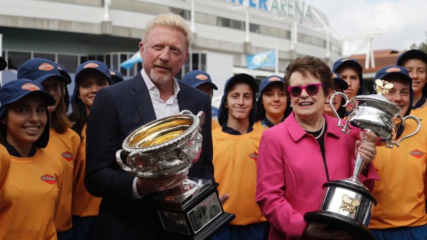 Former champions Boris Becker and Billie Jean King hold the men's and women's trophies ahead of the first round matches on day one of the 2018 Australian Open. 