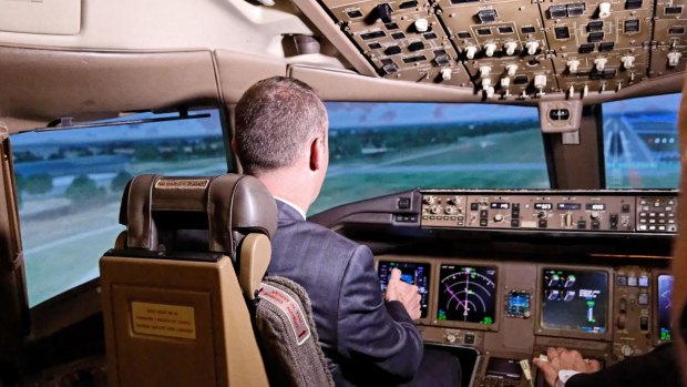 Chief Minister Andrew Barr controlling a simulated Boeing 777 flight out of Changi Airport.