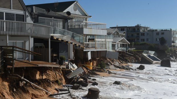 The carnage along the beachfront at Collaroy where 10 properties hang perilously close to the angry sea.
