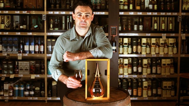 Brad Ward of liquor retailer Dan Murphy's with a 70-year-old bottle of Gordon & MacPhail's The Glenlivet. It is selling for $30,000.