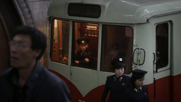 On board: A train conductor and station attendants work in a subway station in Pyongyang on Saturday.