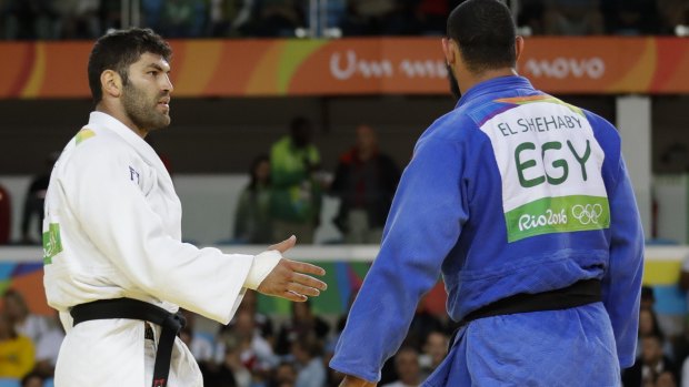 Disrespectful: Egypt's Islam El Shehaby, in blue, declines to shake hands with Israel's Or Sasson after losing during the men's over 100-kg judo competition in Rio on Friday.