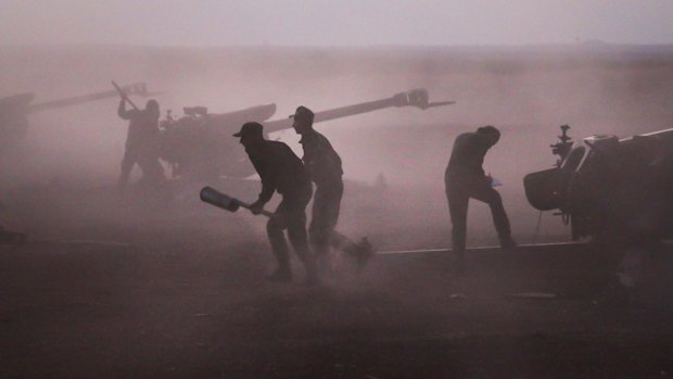 Syrian army personnel load howitzers near the village of Murak in Hama province earlier this month. 