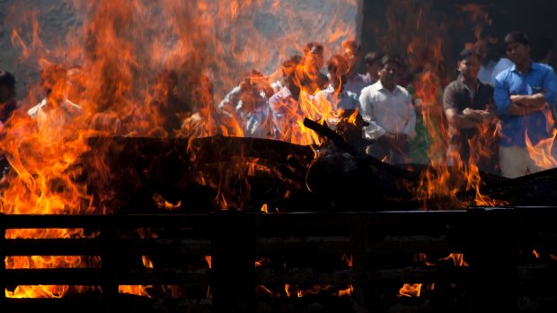Flames rise from the cremation pyre of Srinivas Kuchibhotla at a crematorium in Hyderabad, India.