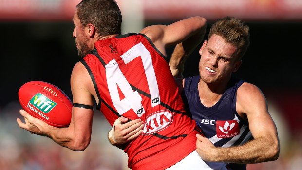 Hayden Crozier tackles James Kelly during the Dockers' win against Essendon.