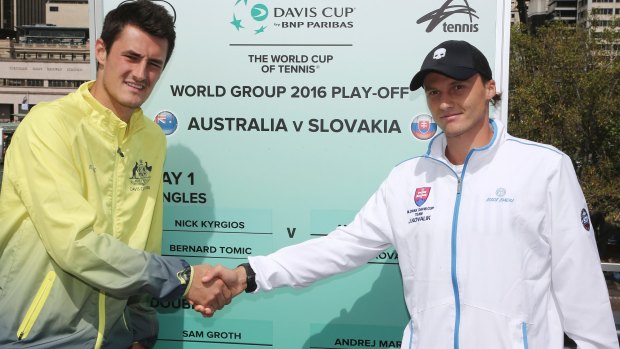 Exchanging pleasantries: Slovakia's Jozef Kovalik shakes hands with Australia's Bernard Tomic after the official draw for the Davis Cup.