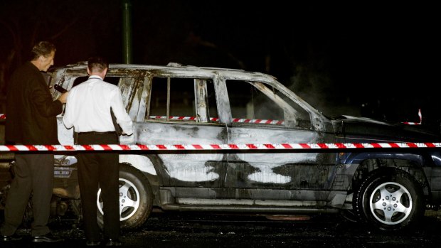 Homicide detectives at the scene in 2008 where Mr Russouw's burnt-out jeep was found in Burwood East.