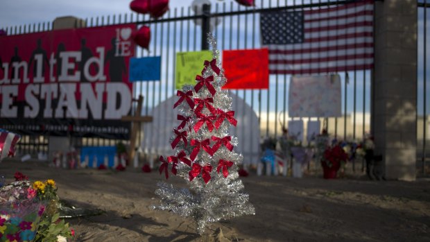 A Christmas tree decorated with 14 ribbons is placed at a makeshift memorial to honour the victims of the massacre.