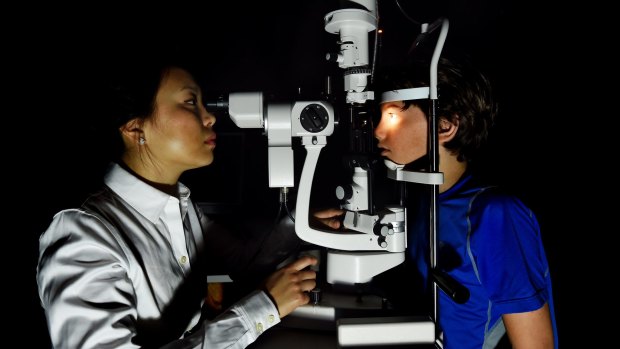 Maxime Jalbert-Locke, right, has an eye examination conducted by Dr Pauline Kang.