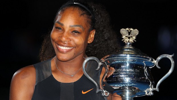 Serena Williams poses with the trophy after winning the Australian Open.