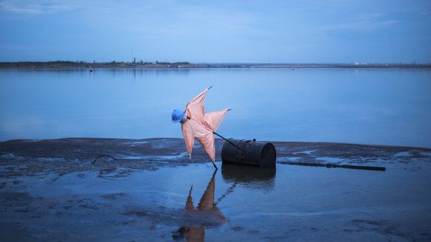 A scarecrow set up in a tailings pond created by oil sands processing north of Fort McMurray, Alberta.