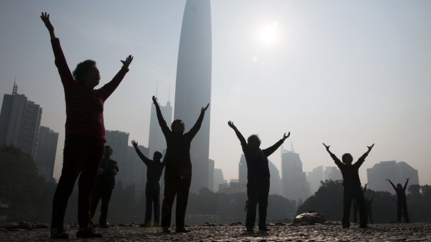 Residents do morning exercises at a park on a hazy day in Shenzhen. The city runs on 60 per cent renewable energy.
