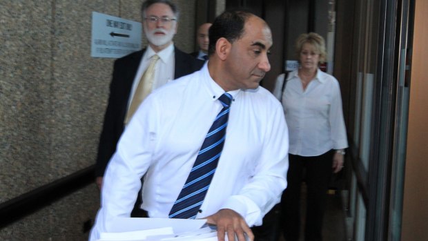 George Dimitriou leaves the NSW Supreme Court. He has been accused in a civil case of defrauding an elderly, illiterate couple. 