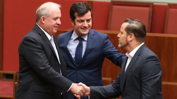 Greens senator Peter Wish-Wilson, born in Singapore is congratulated by Nationals senator John "Wacka" Williams and Iran-born ALP senator Sam Dastyari. 