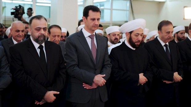 Syria's President Bashar al-Assad  attends Eid al-Fitr prayers at al-Hamad mosque in Damascus.