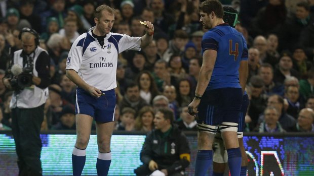 Pascal Pape of France is shown a yellow card.