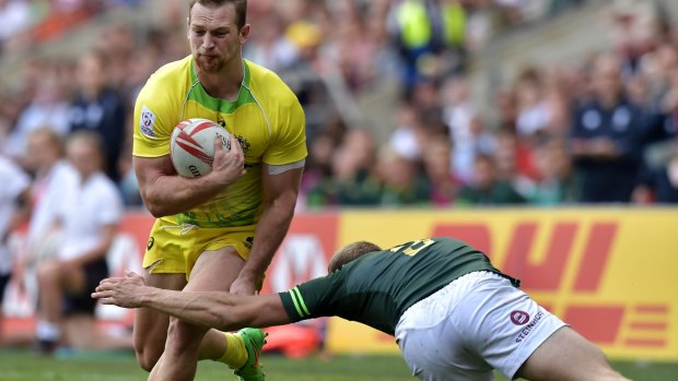 Boyd Killingworth of Australia is tackled by Dylan Sage of South Africa.