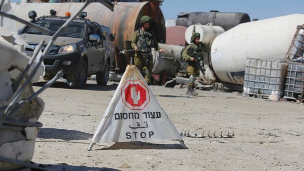 Israeli soldiers set up a security checkpoint  near the occupied West Bank village of Hebron earlier this year.