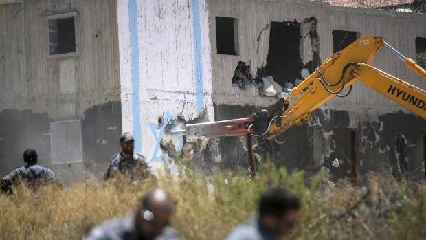 Israeli paramilitary police stand guard during the demolition of the Dreinoff buildings.