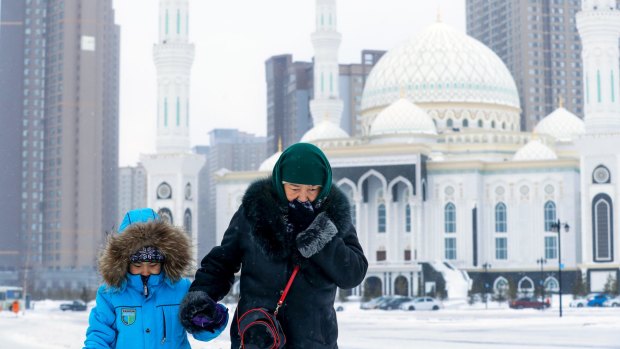 A woman and a child walk in Astana, Kazakhstan, on January 23.