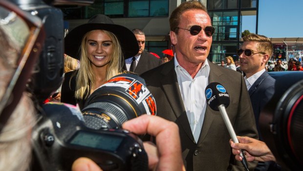 Arnold Schwarzenegger and model Elyse Knowles arrive at the Australian Grand Prix.