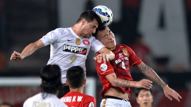 Rising to the challenge: Tomi Juric battles for the ball against Guangzhou Evergrande.