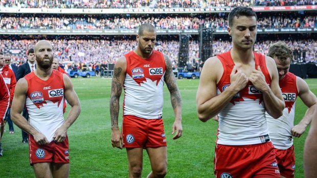 Tough to take: Dejected Swans players leave the field.
