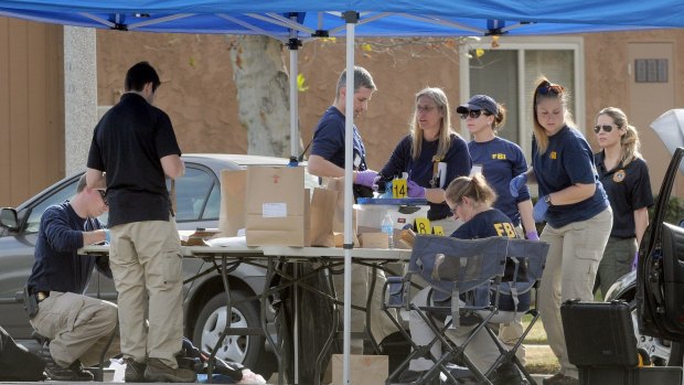 FBI officials continue pulling evidence from a car at the home of the San Bernardino mass shooting suspects.