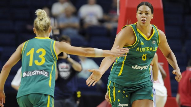 Cambage, right. slaps hands with teammate Erin Phillips.