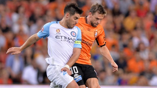 Toe to toe: Brett Holman of the Roar (right) and Bruno Fornaroli of Melbourne City compete for the ball. 