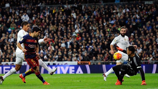 Back of the net: Luis Suarez beats Keylor Navas to score his team's fourth goal during the La Liga match between Real Madrid and Barcelona at Estadio Santiago Bernabeu.