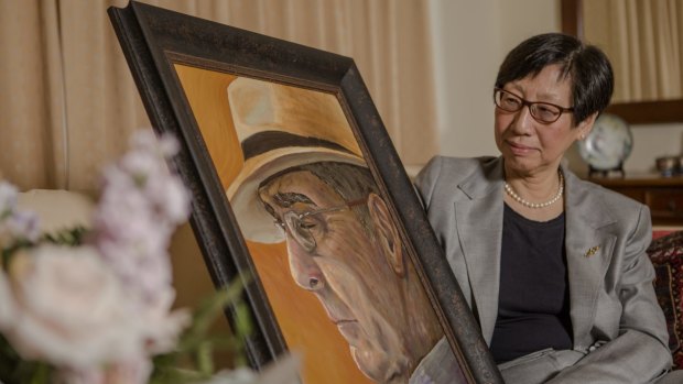 Adjunct Associate Professor of Economics Dr Suiwah Leung, with a painting by her daughter Emily Dean, of her late husband Ron Dean.
