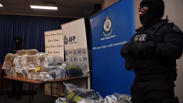 AFP officers stand guard over some of the cocaine seized during the Christmas Day drug bust.