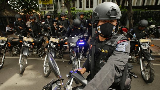 Indonesian Police arrive to search for suspicious materials as they anticipate terror attacks prior to the Christmas Eve mass at the Cathedral in Jakarta.