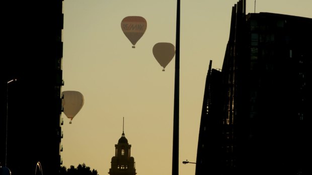 Flinders Street and hot air balloons this morning.