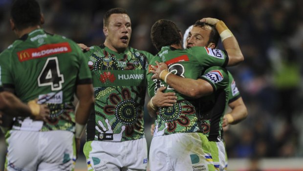 Green Machine clicks into gear: Josh Hodgson is congratulated after he scores a try.