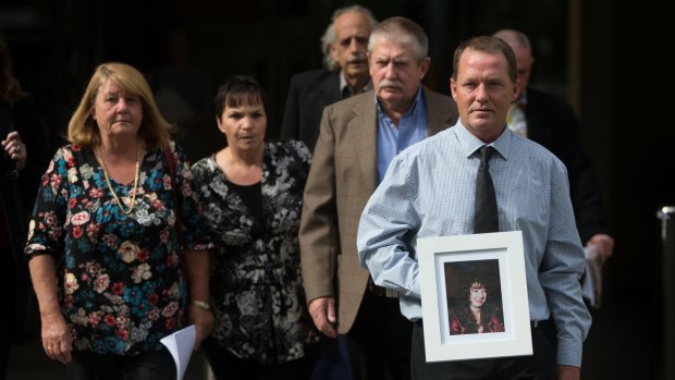 John and Wendy Thompson and family members leave the Coroners Court with a photo of Kelly, who died at the hands of her partner. 