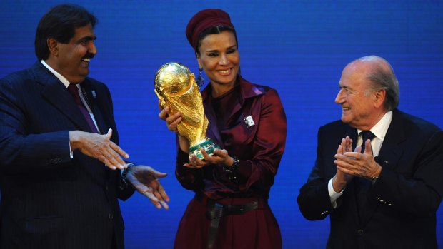 Sheikh Hamad bin Khalifa Al-Thani and Sheikha Mozah bint Nasser Al Missned are presented with the World Cup Tophy by FIFA President Sepp Blatter.