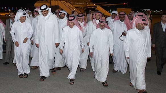 The Emir of Qatar, Sheikh Tamim bin Hamad al-Thani, second left in front row, receives freed Qataris at Doha airport on April 21 after reputedly paying $US1 billion for their release from Iraq.